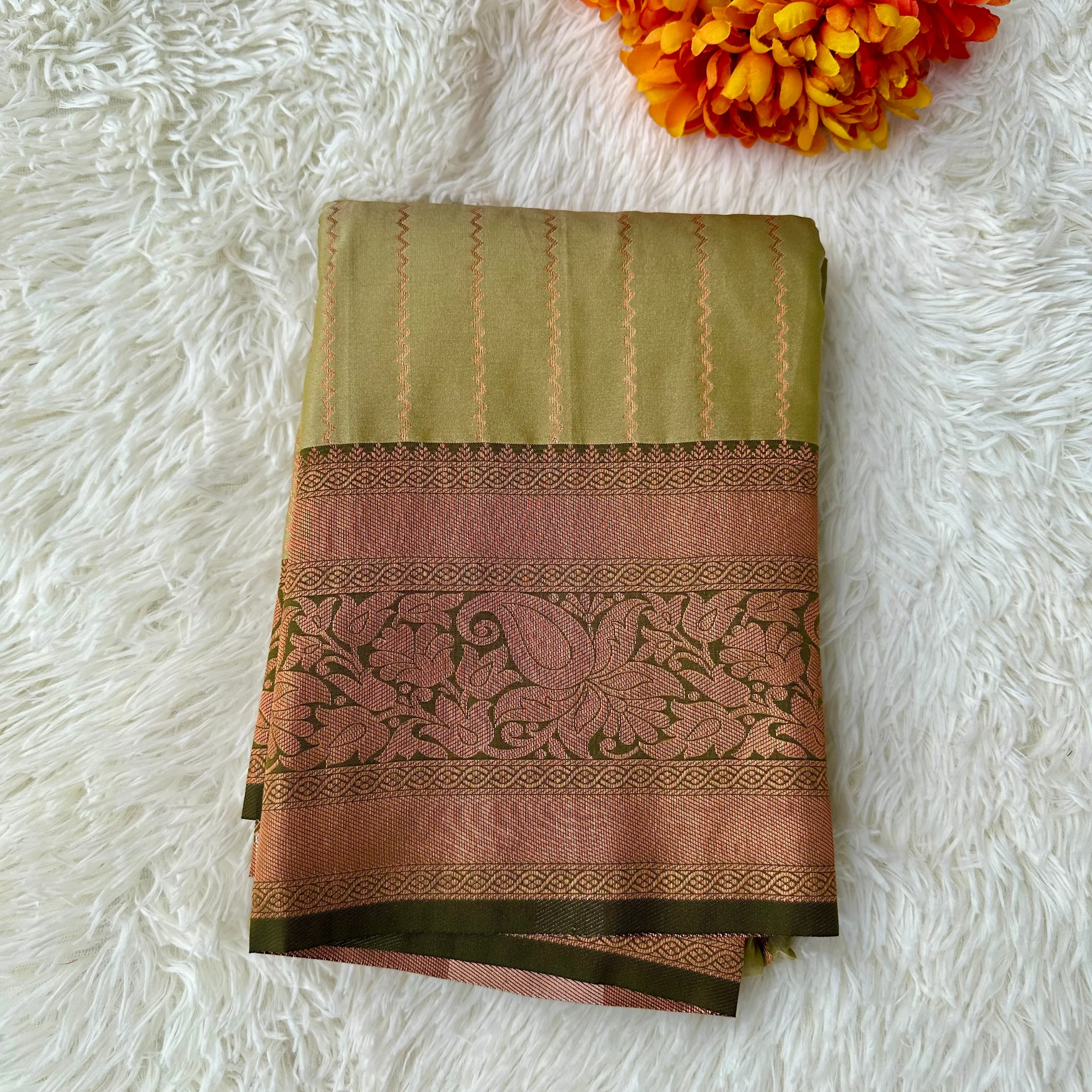 The Natural Beauty Olive Green Color Saree With The Rich Copper Zari border